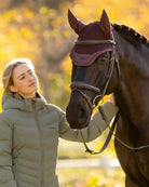 LeMieux Essence Acoustic Fly Hood - Damson, shown on horse with woman standing next to, outdoors | Horse Care | Malvern Saddlery