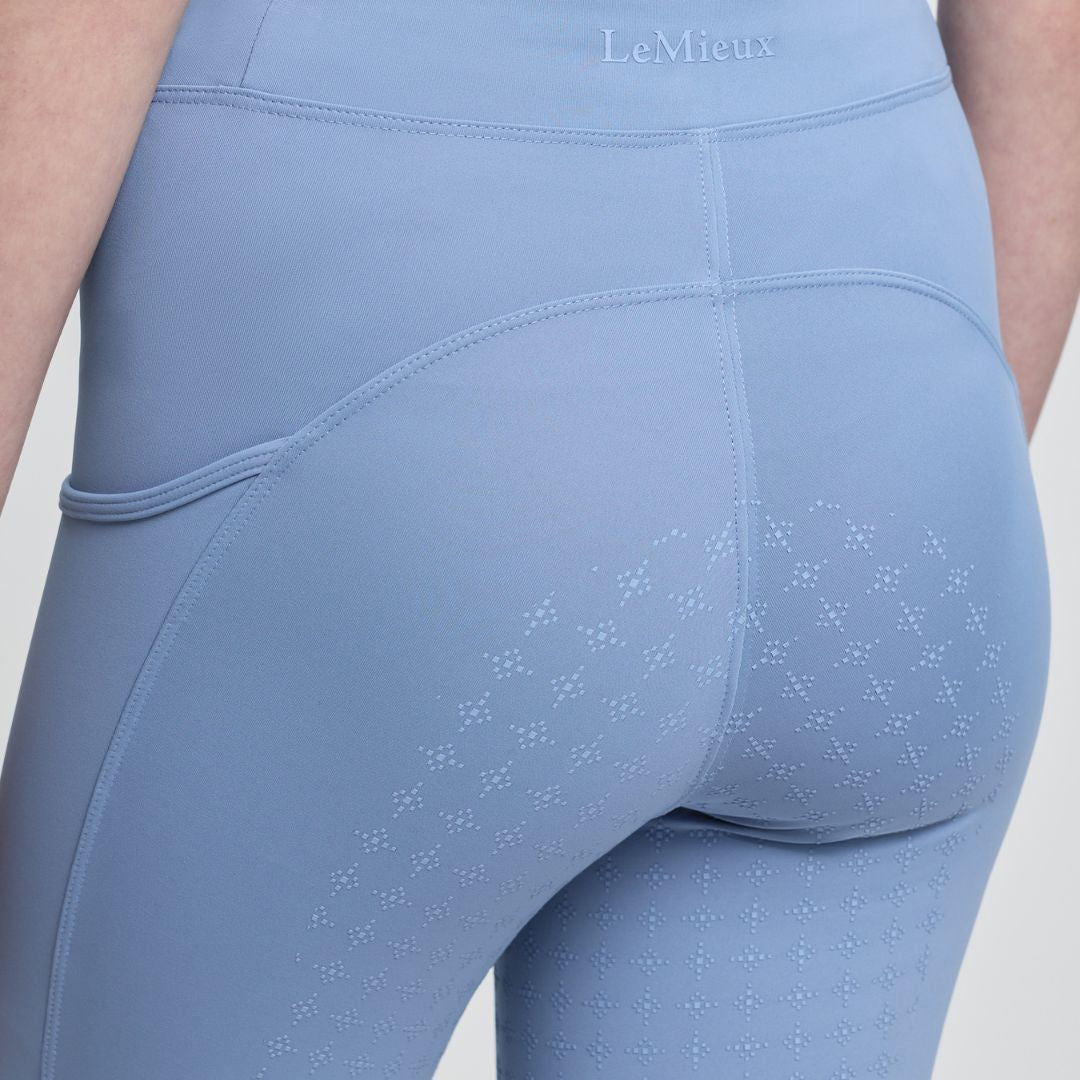 LeMieux Young Rider Orla Pull Ons - Powder Blue; shown on model, full seat grip close up | Malvern Saddlery