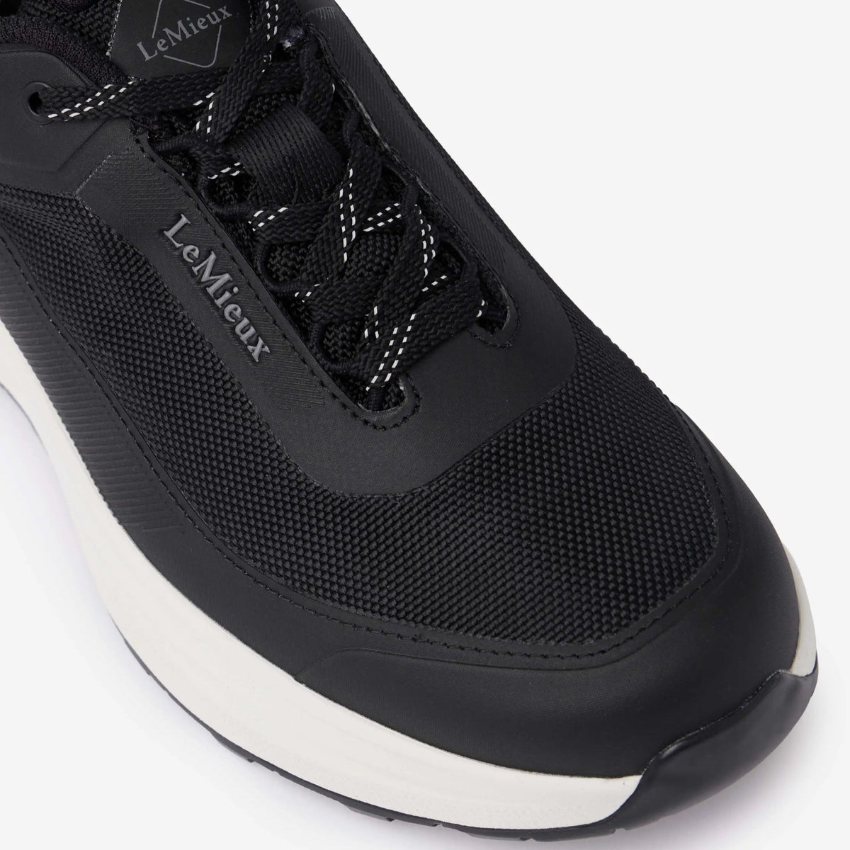 Close-up top view of black LeMieux Kanta Waterproof Sneaker showing durable upper mesh and lace-up closure.