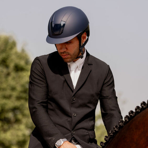 KASK Kooki Equestrian Helmet, Navy Matte, shown on man wearing show coat on horse | Malvern Saddlery