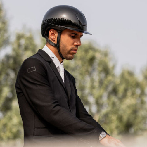 KASK Kooki Equestrian Helmet, Black Shine, shown on man wearing show coat on horse | Malvern Saddlery