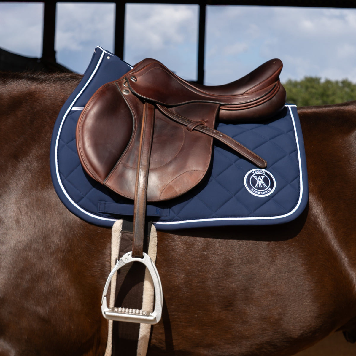 Yagya Performance Jump Saddle Pad - Navy, on the horse | Malvern Saddlery