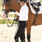 WON Equestrian Stay Dry Waterproof Breeches - black, lifestyle on rider with horse | Malvern Saddlery