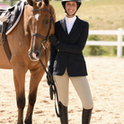 WON Equestrian Stay Dry Waterproof Breeches - Beige, on rider standing next to chestnut horse | Malvern Saddlery