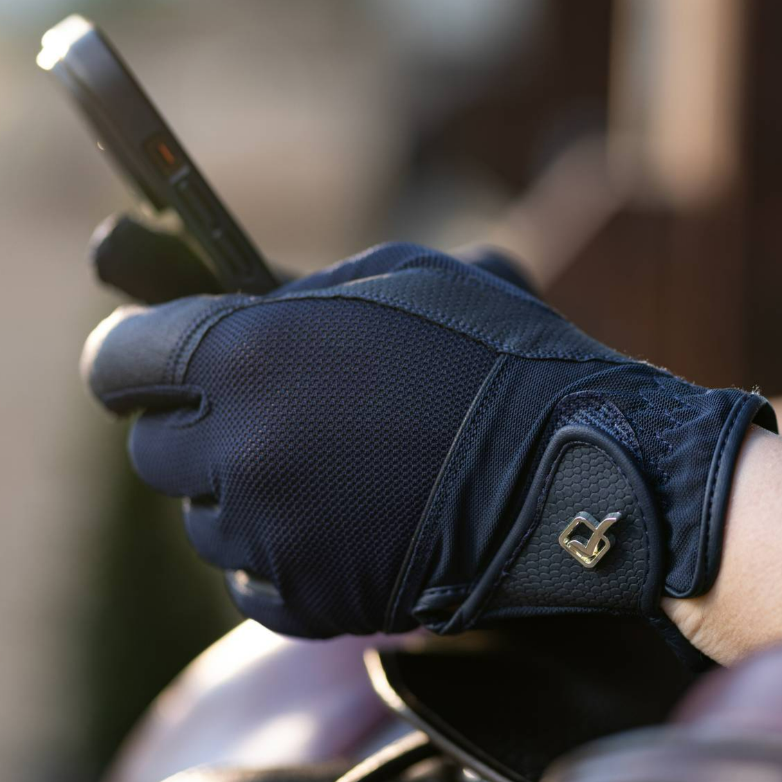 LeMieux Pro Mesh Glove - Navy - lifestyle image shown on hands holding reins | Malvern Saddlery