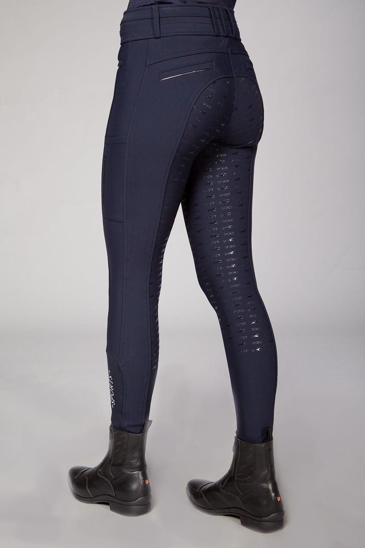 Schockemoehle Ladies Winter Heather Breech - Navy; shown on woman side/back view | Full Seat Breeches | Malvern Saddlery