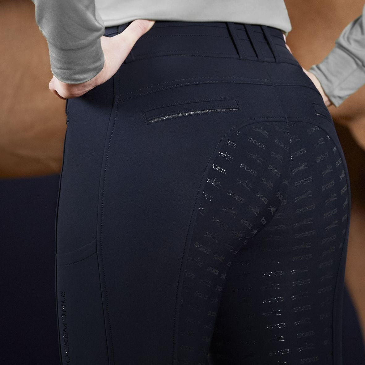 Schockemoehle Ladies Winter Heather Breech - Navy; on woman with horse in background| Full Seat Breeches | Malvern Saddlery