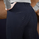 Schockemoehle Ladies Winter Heather Breech - Navy; on woman with horse in background| Full Seat Breeches | Malvern Saddlery