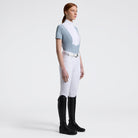 Cavalleria Toscana Women's Competition Shirt in Technical Jersey with white poplin colllar & hidden buttons - light blue, shown on model with white breeches, riding boots | Equestrian Show Shirts  | Malvern Saddlery