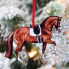 Chestnut Horse Dressage Ornament - wood, hands from red ribbon with blurred tree background | Equestrian Gifts | Malvern Saddlery