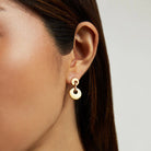 Dean Davidson Petit Pavé Mini Drop Earrings - Gold, close up on figure | Malvern Saddlery