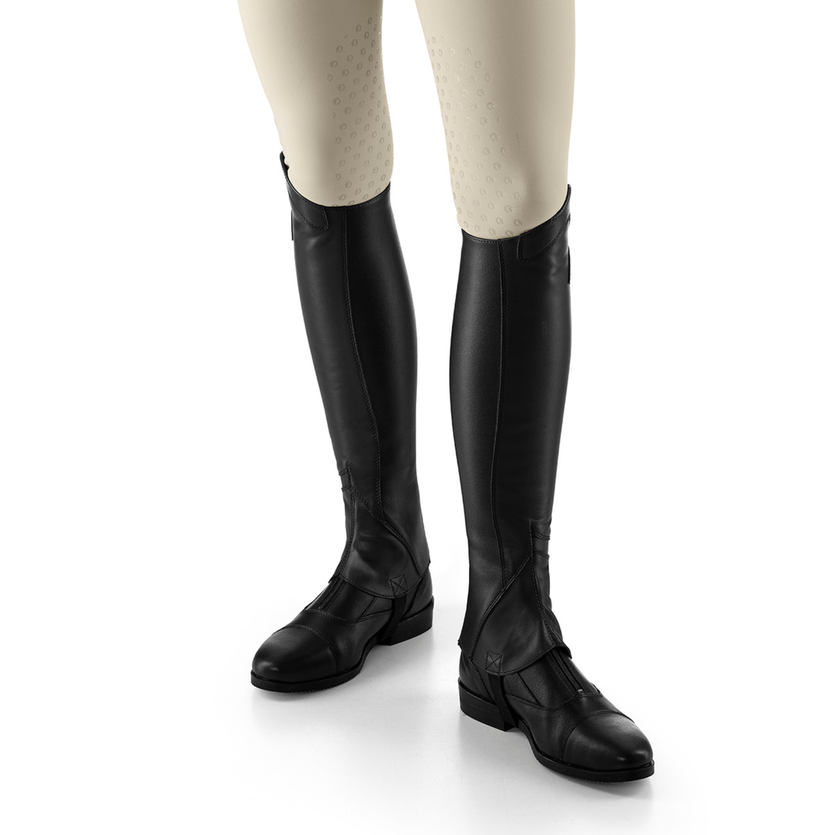 EGO7 Lyra black leather equestrian half chaps worn over paddock boots with beige riding breeches, side profile and front angle view