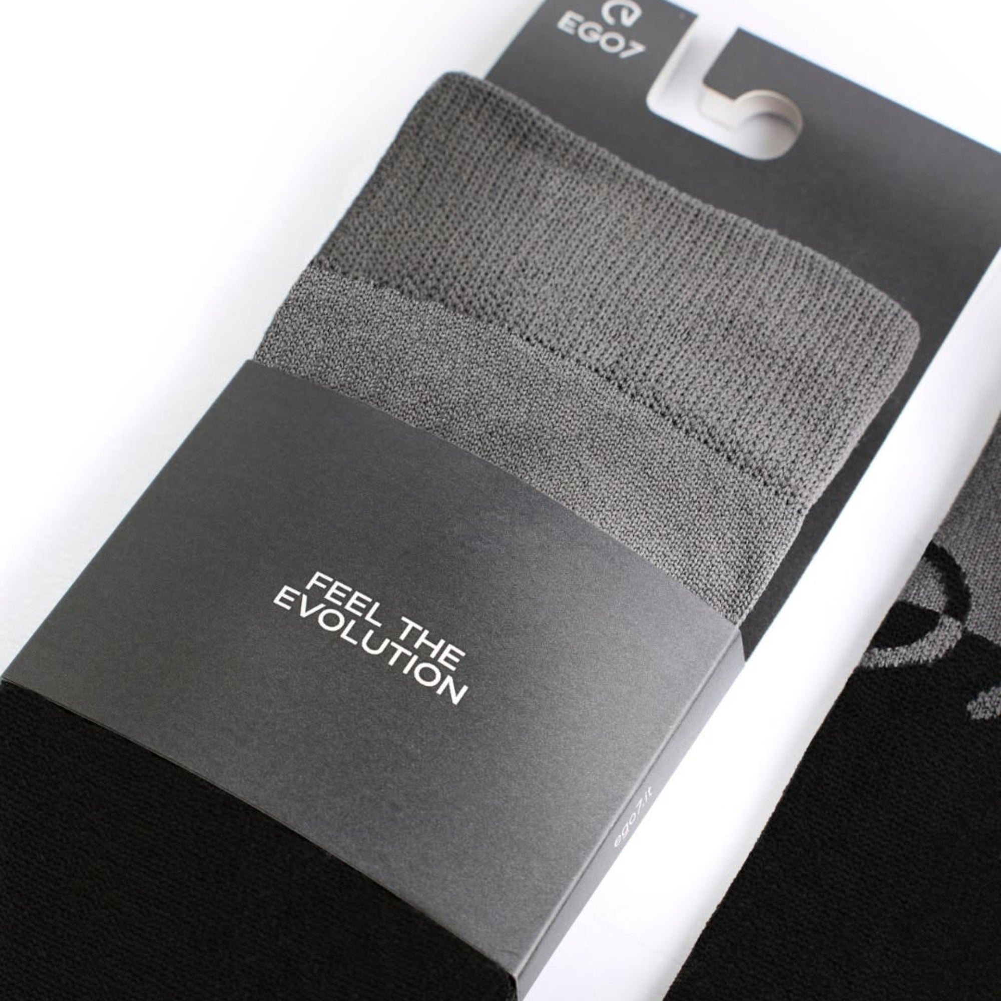 Close-up of packaged EGO7 MV riding socks in grey and black with branded cardboard sleeve