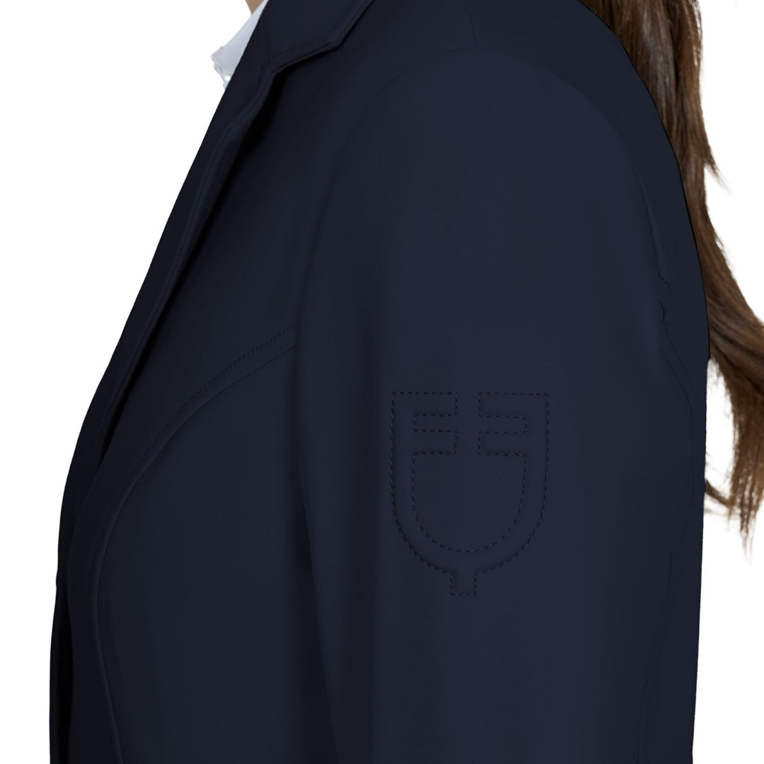 Equestro Women's Girasol Competition Jacket - Navy Blazer; left shoulder embossed logo detail - shown on model, white background | Equestrian Show Coats | Malvern Saddlery