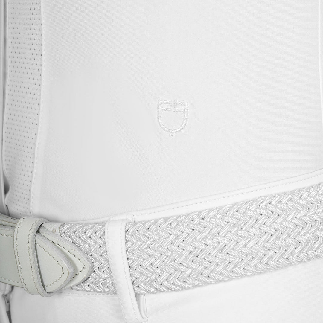 Equestro Women's Long Sleeve Competition Shirt - White; close up of logo above left waist shown on model on white background | Show Shirts | Malvern Saddlery