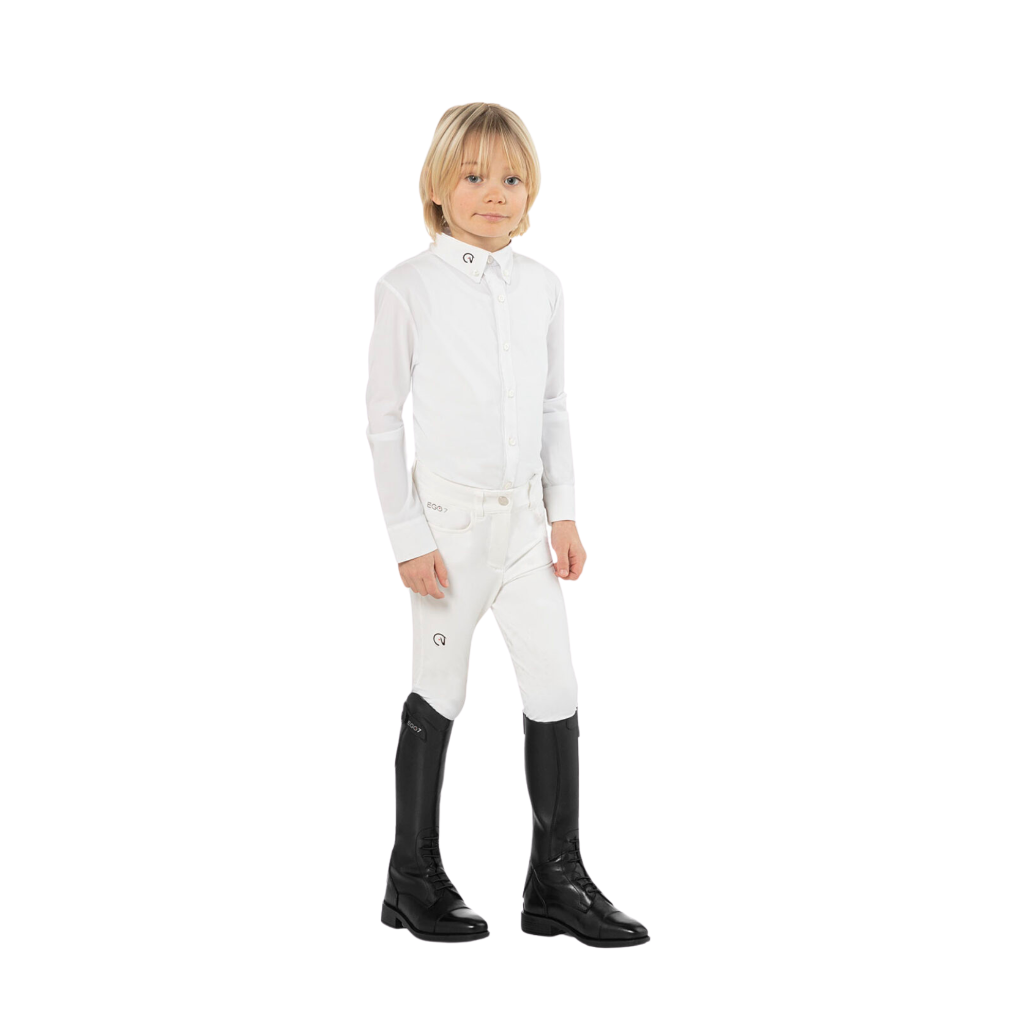 Young rider wearing EGO7 Aster kids black leather equestrian field boots with white show shirt and white riding breeches, full-body standing view