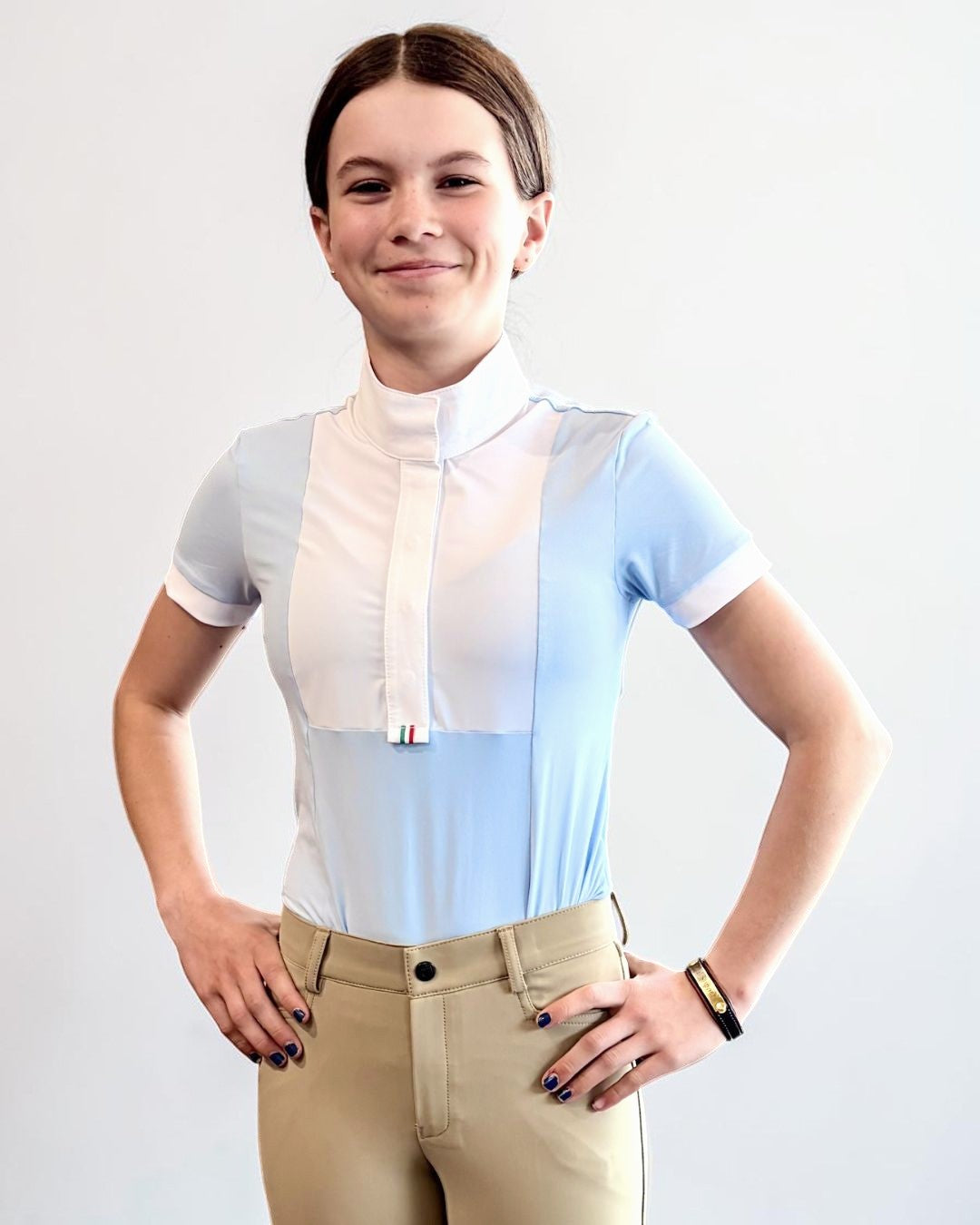 For Horses Ariel Short Sleeve Girls Show Shirt -Sky Blue - shown on young girl on gray background | Young Rider Competition Shirts | Malvern Saddlery