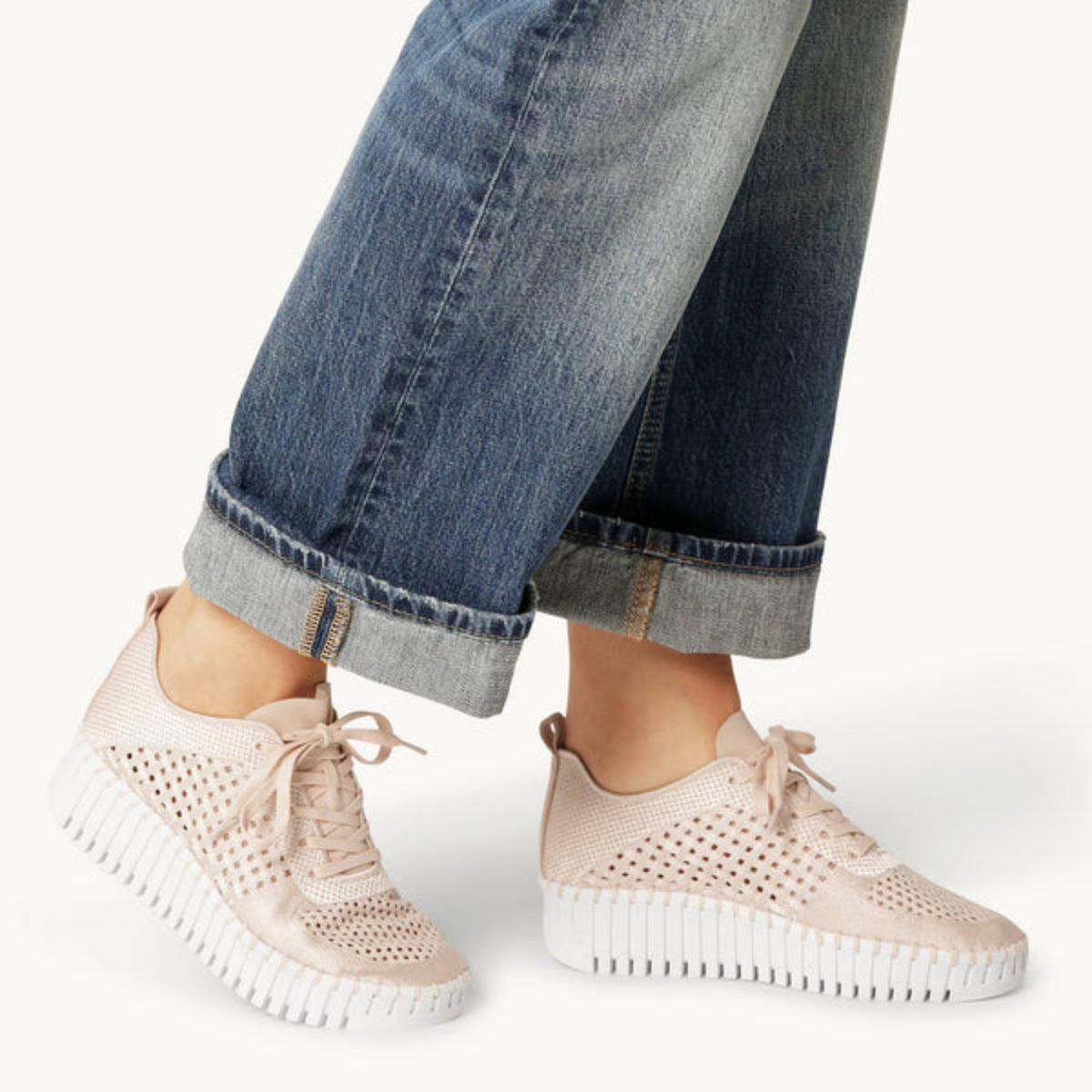 On-foot view of a model wearing Ilse Jacobsen Tulip 4271 embroidered platform sneakers in Kit White paired with cuffed denim jeans, showing the lightweight platform rubber soles and breathable perforated upper