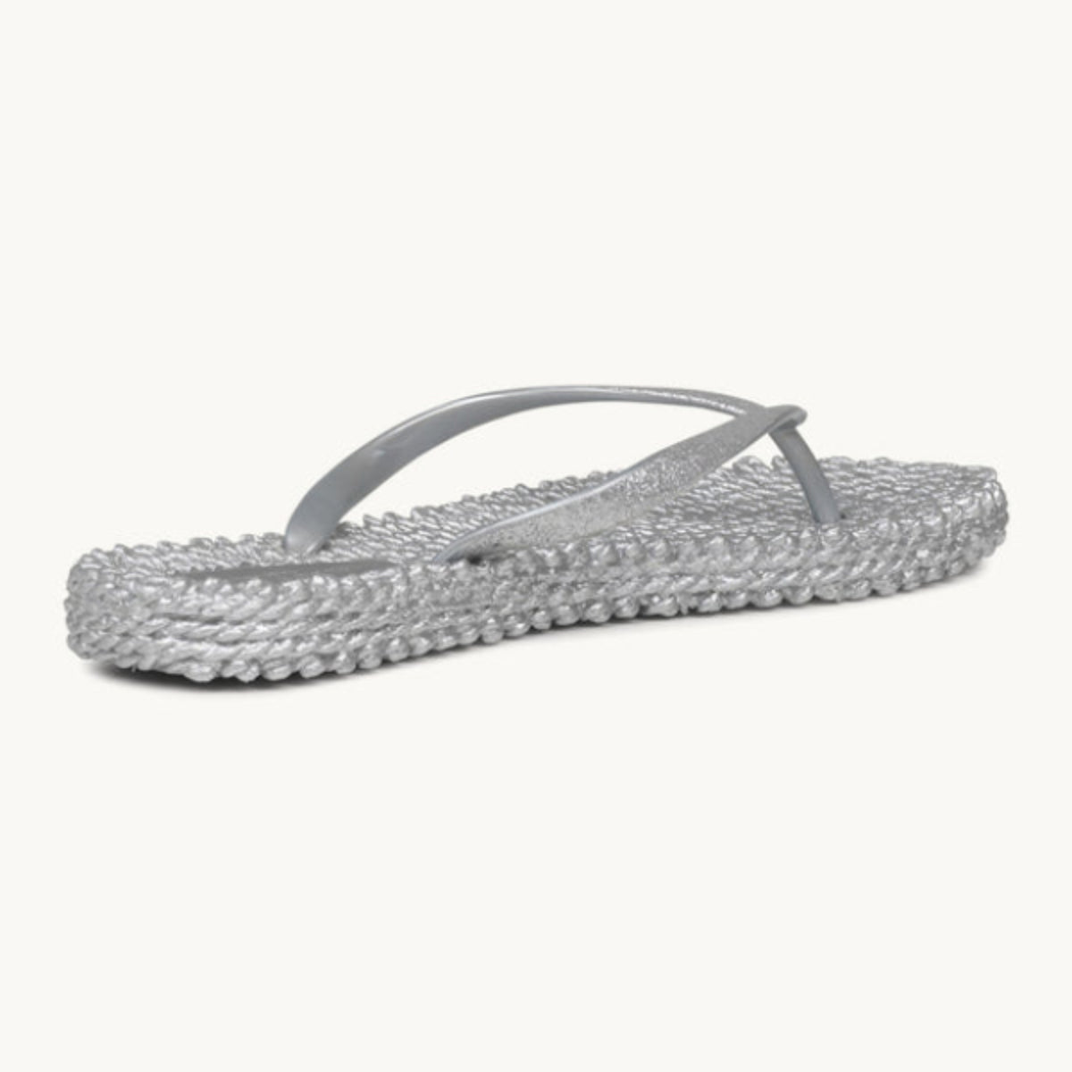 Ilse Jacobsen Cheerful silver glitter flip flops angled view featuring a textured massaging footbed