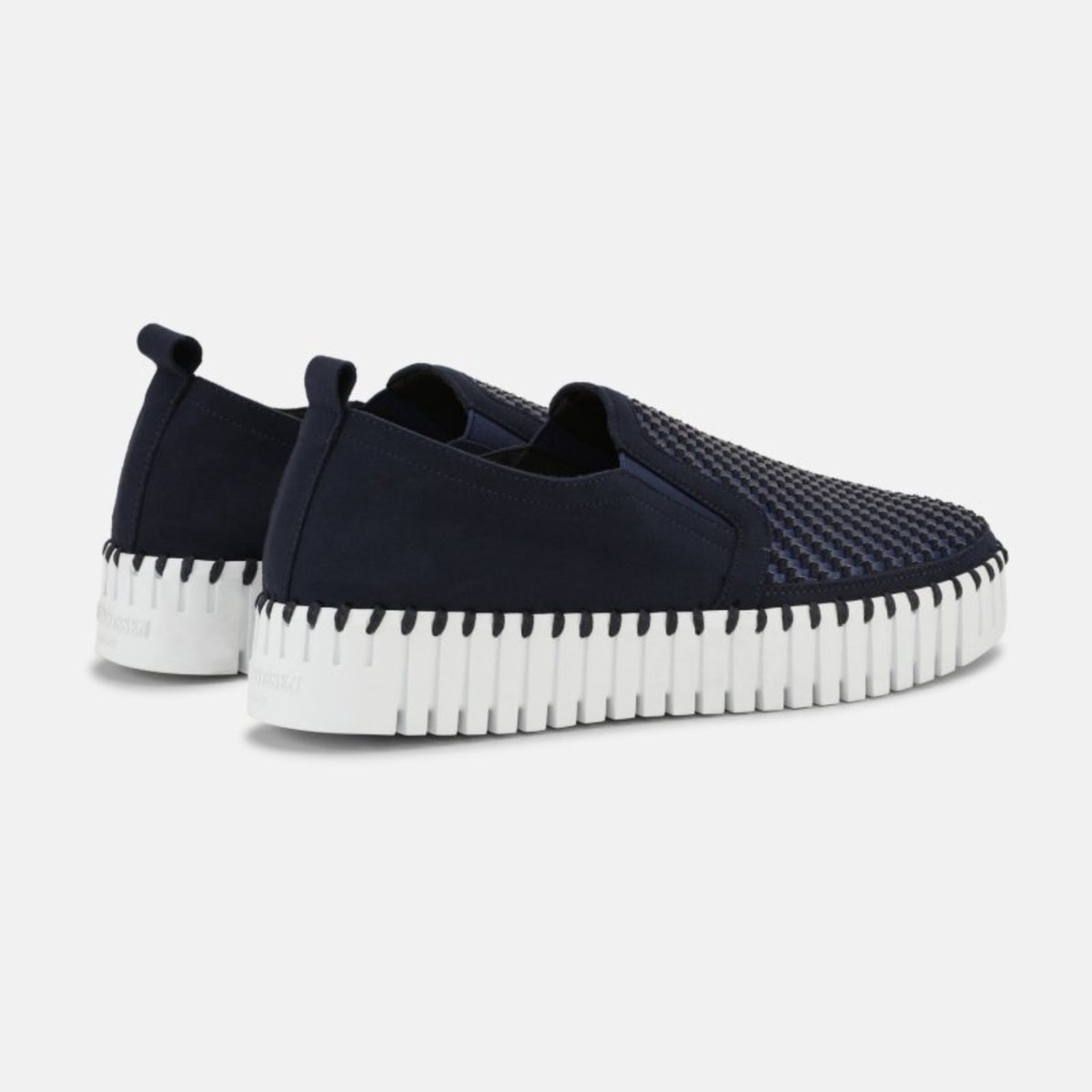 Back three-quarter view of women's Ilse Jacobsen Tulip indigo blue slip-on shoes with textured woven uppers and cushioned platform soles.