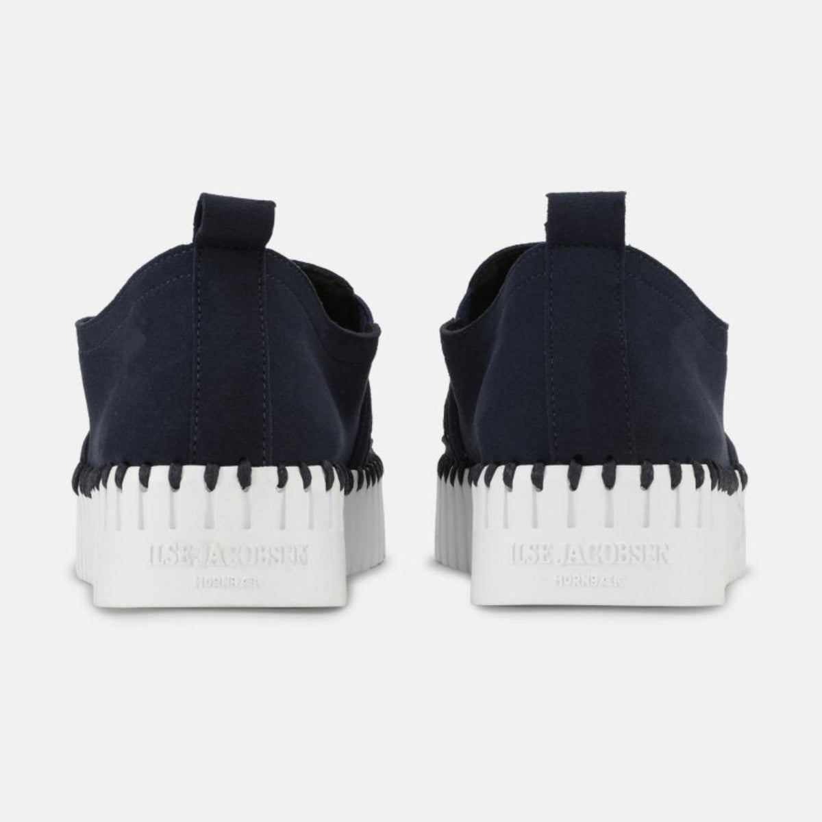Back view of women's Ilse Jacobsen Tulip indigo blue slip-on shoes featuring heel pull tabs and thick white platform soles.
