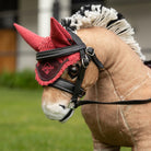 LeMieux Toy Pony Ear Bonnet - Cranberry, shown on 'Oskar' with bridle | Malvern Saddlery