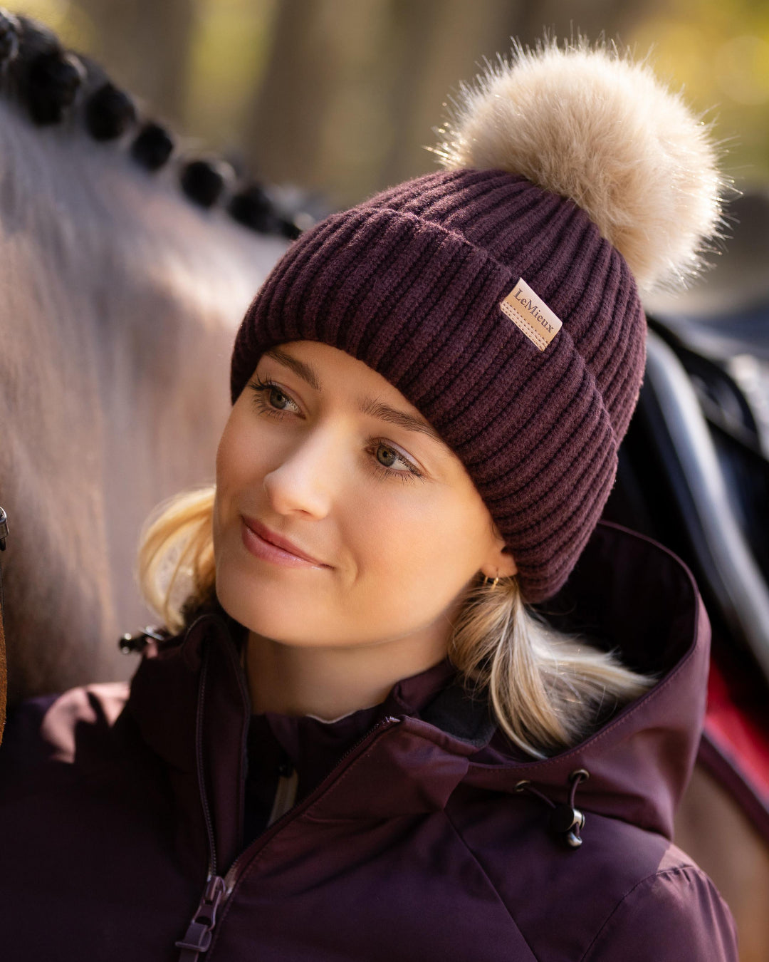 LeMieux Clara Rib Beanie - Damson Dark Red - shown on woman next to horse