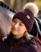LeMieux Clara Rib Beanie - Damson Dark Red - shown on woman next to horse