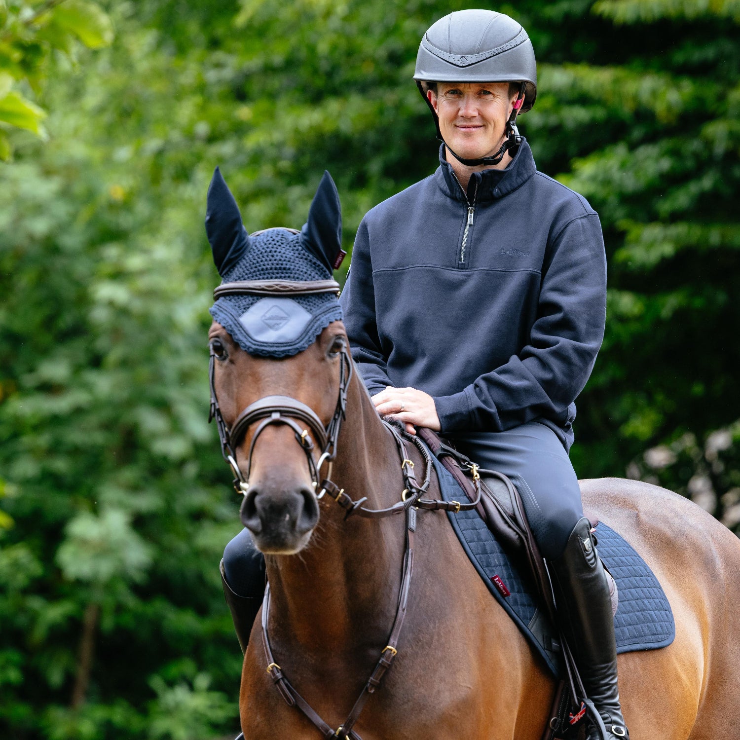 LeMieux Men's Quarter Neck Sweatshirt - Navy, shown on man riding horse  | Malvern Saddlery