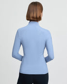 LeMieux Classique Women's Base Layer Top - Powder Blue; back view shown on woman, gray background | Malvern Saddlery