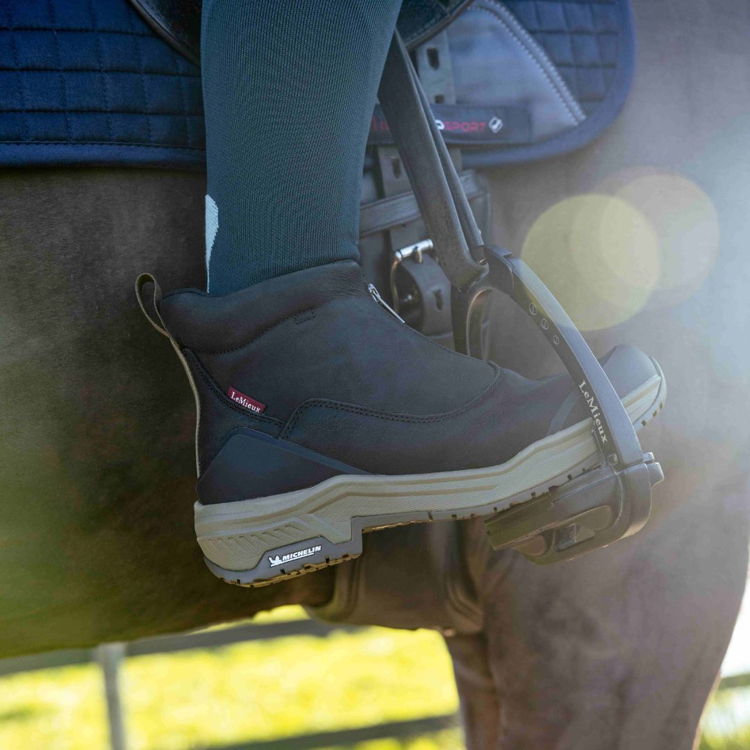 LeMieux Trex Waterproof Zip Boots = Black, shown on foot in stirrup | Malvern Saddlery