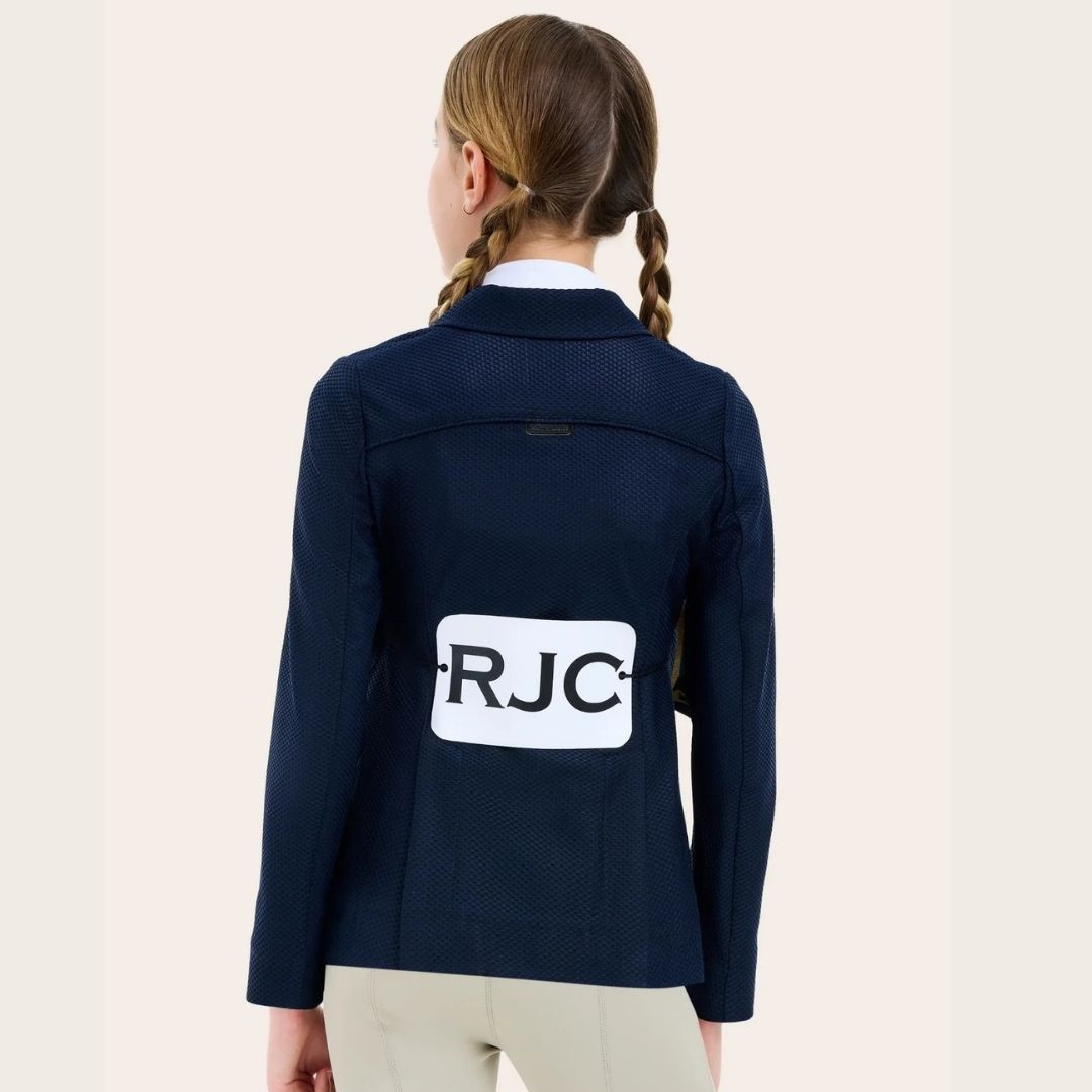 RJ Classics Addison Air Jr Mesh Girls Show Coat - Navy; back view on young rider with competition tag attached 'RJC' | Young Rider Competition Apparel | Malvern Saddlery