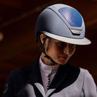 KASK Star Lady Hunter Equestrian Helmet - Navy;  close up worn by rider wearing showcoat with blurred brown background | Wide Brim Helmets | Malvern Saddlery