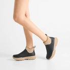 Pair of Woden Irene Waterproof Boots - Black/Coffee Cream on model against white background | Malvern Saddlery