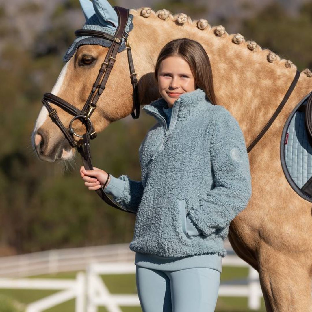 LeMieux Young Rider Tia Teddy Fleece - Glacier, shown on young girl with palomino horse | Malvern Saddlery