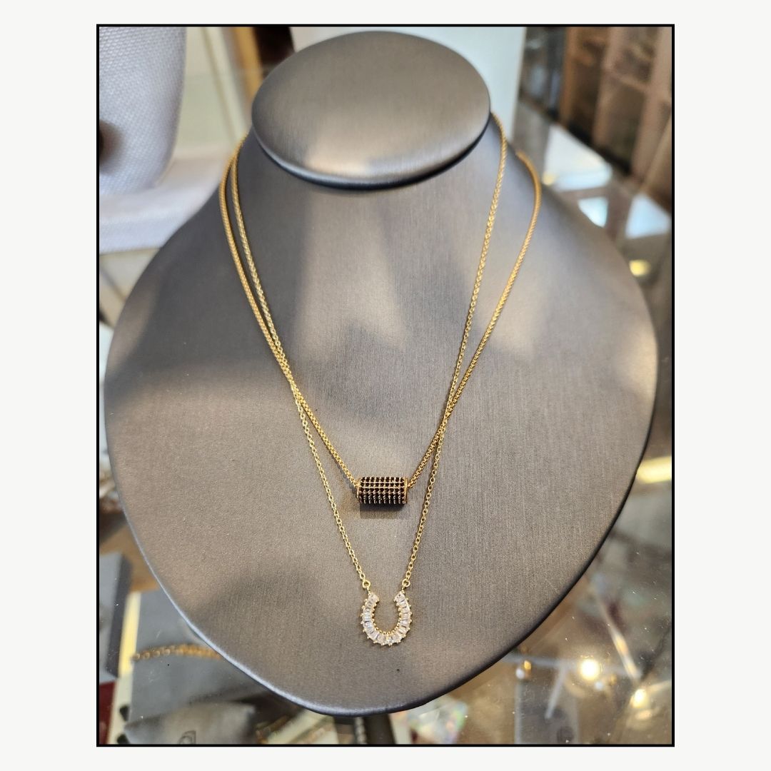 Dean Davidson Petit Pavé Mini Tube Necklace - Black Crystal, shown layered with horseshoe crystal  necklace in store display | Malvern Saddlery