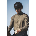 Kask Dogma Chrome Equestrian Helmet - Black; shown on rider wearing sunglasses with sky background| Malvern Saddlery