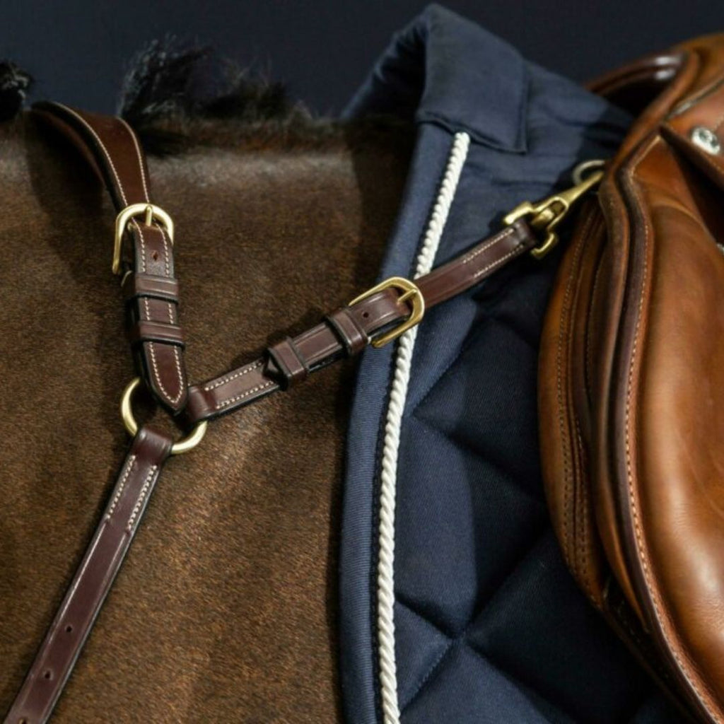 Dy'on Anatomic Breastplate - Brown, Cream Stitching, Brass Buckles - shown on horse attached to saddle | Malvern Saddlery