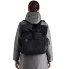 Black EGO7 Axel waterproof equestrian backpack worn on back showing storage compartments and side mesh pockets