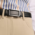Black EGO7 Elegance leather belt with a rectangular silver buckle worn with beige riding breeches and a blue striped shirt