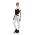Full view of a woman wearing the black and white EGO7 Mathilde Women's Short Sleeve Show Shirt with white riding breeches and black boots