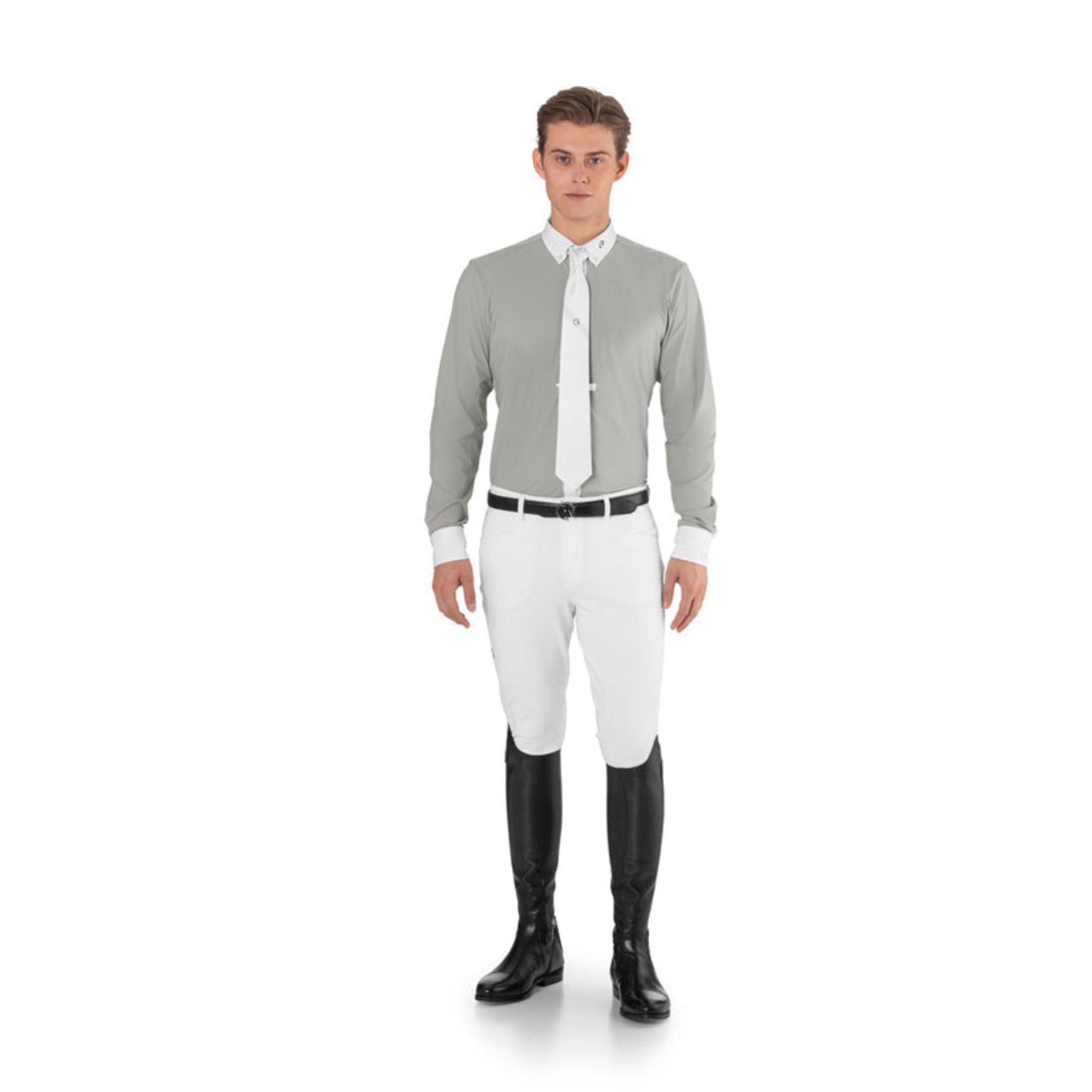 Male rider wearing the white EGO7 men's equestrian show tie, grey long-sleeve competition shirt, and white breeches.