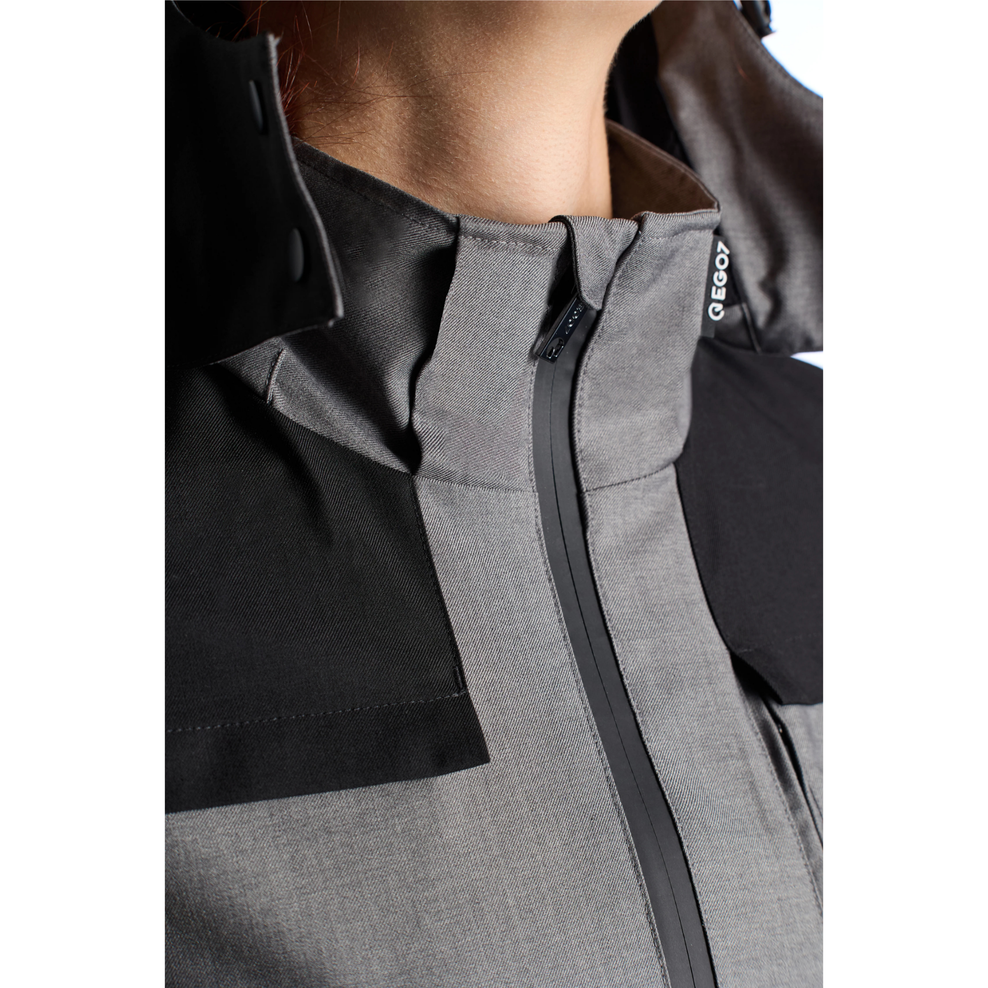 Close-up view of the high collar zip closure and EGO7 branded tag on the Skye women's equestrian jacket.