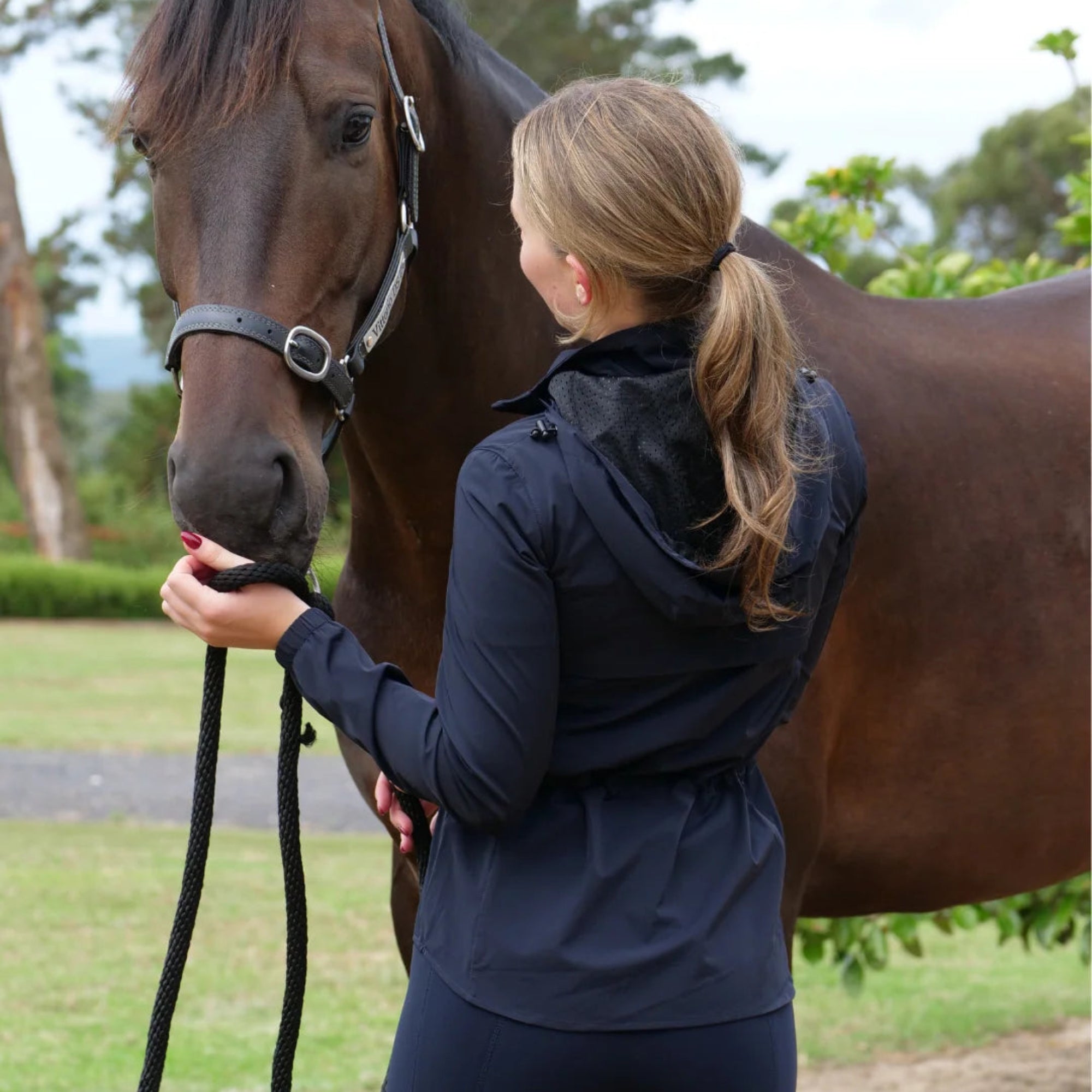 EGO7 MV Wind Cheater Women's Jacket in Navy worn with a horse in side