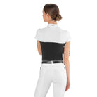 Back view of a equestrian rider wearing the black and white EGO7 Mesh Women's Short Sleeve Show Shirt with stand-up collar