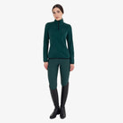 Equestro Women's High Neck Fleece 3/4 Zip Sweatshirt in Pine Grove worn with breeches and tall boots