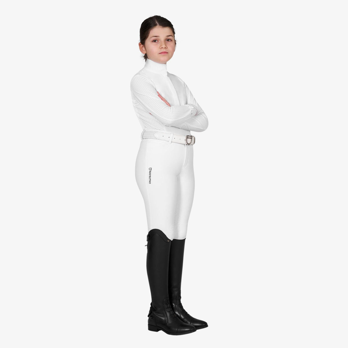 Equestro Girls' Long Sleeve Competition Polo in White worn with breeches and tall boots