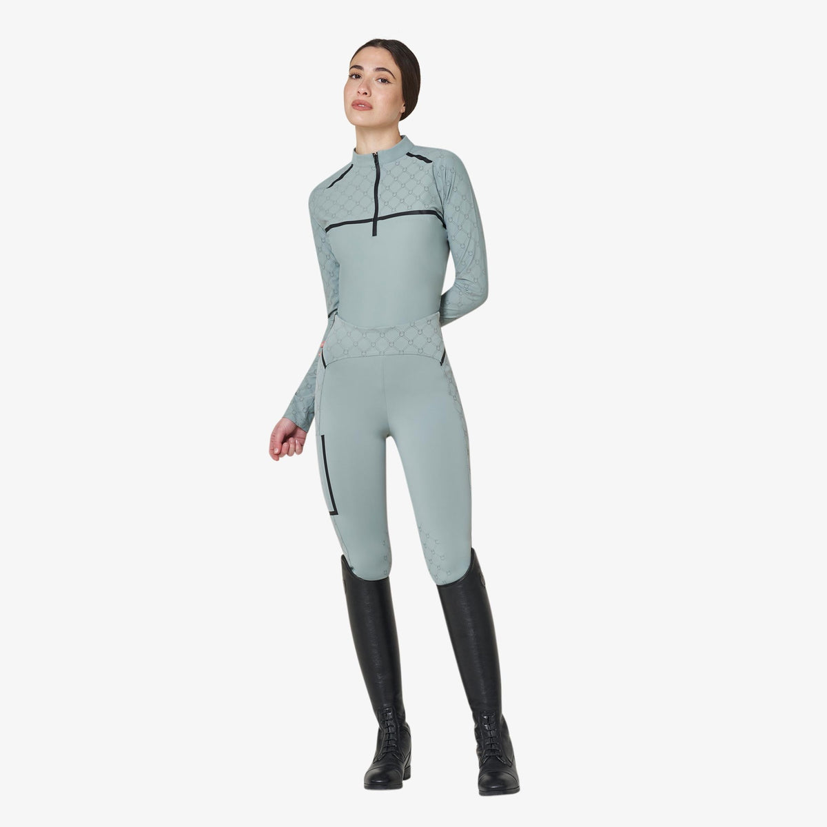 Equestro Women's Monogram Long Sleeve Training Polo in Slate Grey worn with breeches and tall boots
