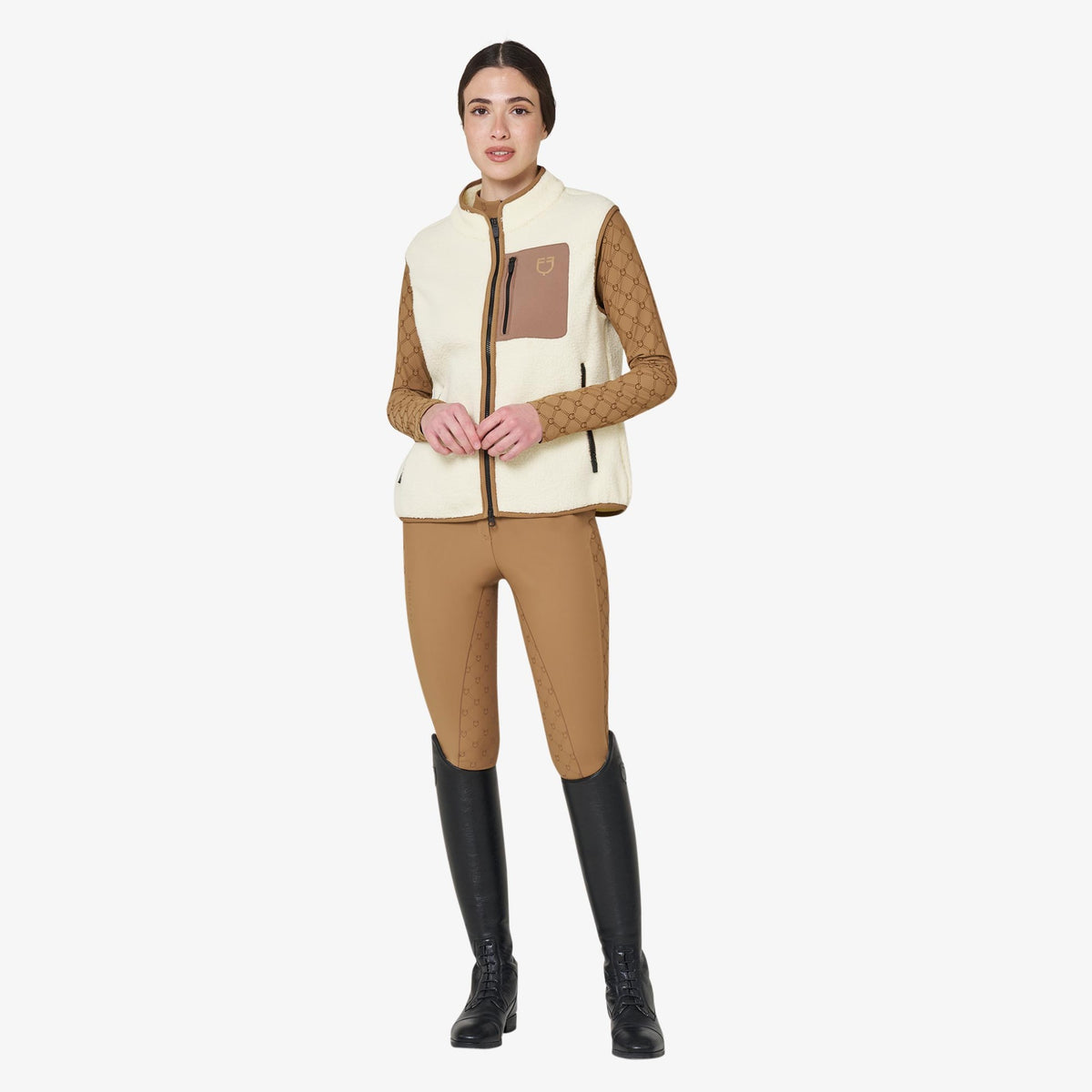 Equestro Women's Teddy Fleece Vest in Antique White worn with breeches and tall boots