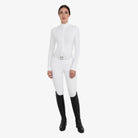 Equestro Women's Winter Competition Polo in White worn with breeches and tall boots